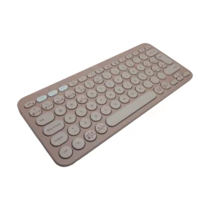 Logitech K380S teclado inalámbrico compacto color rosado con teclas redondas en distribución español; vista en perspectiva frontal sobre fondo blanco